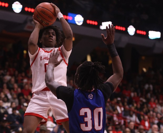 Homewood-Flossmoor point guard Jayden Tyler (0) shoots a layup over the outstretched hands of Curie guard Mason Minor (30) during the Class 4A UIC Supersectional at Credit Union 1 Arena in Chicago on Monday, March 4, 2024. (Trent Sprague/for the Daily Southtown