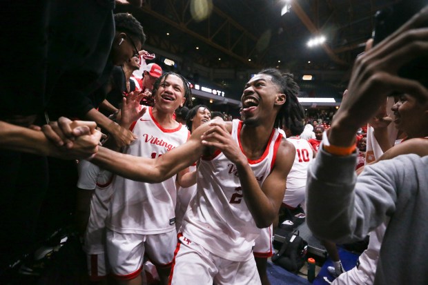 Homewood-Flossmoor guard Bryce Heard (2) celebrates with the rest of the Homewood-Flossmoor team after defeating Curie during the Class 4A UIC Supersectional at Credit Union 1 Arena in Chicago on Monday, March 4, 2024. (Trent Sprague/for the Daily Southtown)