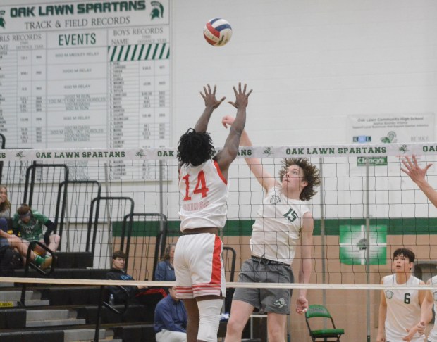 Oak Lawn's Oisin Walsh (15) tries to get the ball past the block again Homewood-Flossmoor during a nonconference match in Oak Lawn on Wednesday, March 20, 2024. (Jeff Vorva / Daily Southtown)