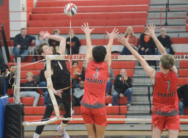 Lincoln-Way West's Colin Dargan, left, pounds the ball against Marist during a nonconference match in Chicago on Wednesday, March 27, 2024. (Jeff Vorva / Daily Southtown)