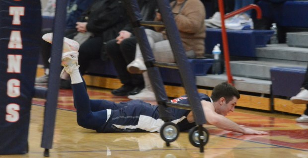 St. Rita's Aidan Peloquin hits the ground chasing down a ball against Sandburg during a nonconference match in Chicago on Tuesday, March 26, 2024. (Jeff Vorva / Daily Southtown)