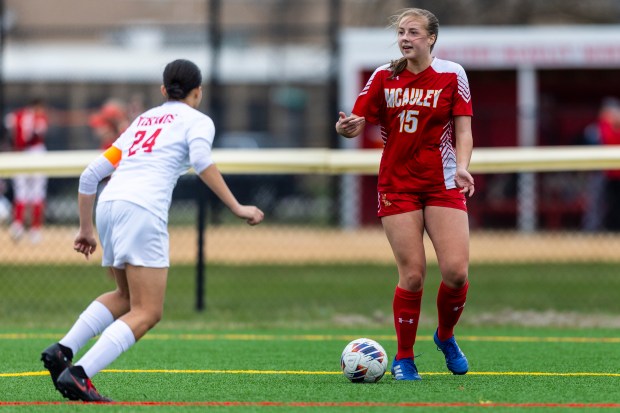 Mother McAuley's Alina Mannion (15) looks for a passing lane as Homewood-Flossmoor's Ariel Rose (24) pressures her during a nonconference game in Chicago on Monday, March 25, 2024. (Vincent D. Johnson/for the Daily Southtown)