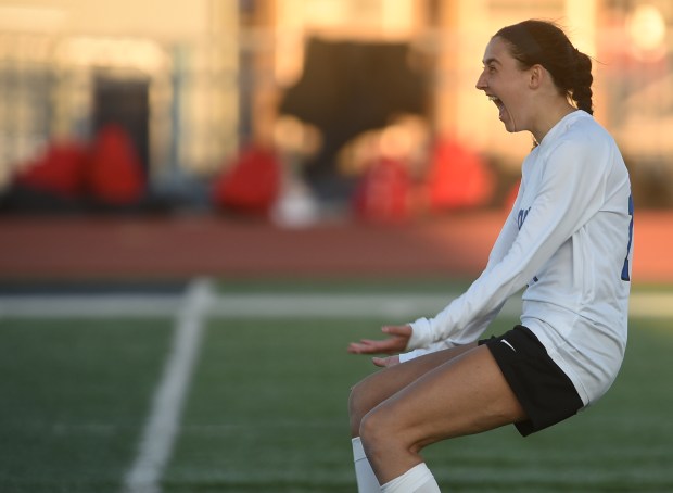 Lincoln-Way East's Mia Hedrick (14) turns around to her teammates after defeating Lincoln-Way Central in penalty kicks during the Windy City Ram Classic semifinals Tuesday, March 19, 2024 in Burbank, IL. (Steve Johnston/Daily Southtown)