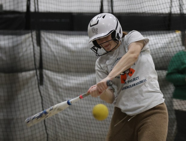 Mia Delisi takes batting practice during a team workout at Oak Forest High School in Oak Forest on Monday, March 18, 2024. (Trent Sprague/Chicago Tribune)