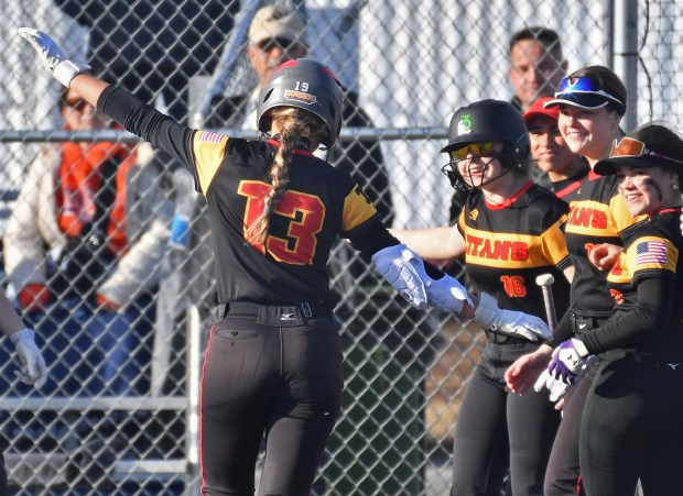 Tinley Park's Megan Piotrowski (13) is greeted by teammates at home plate after hitting a home run during a game against Stagg Tuesday, March 19, 2024, in Palos Hills.(Jon Cunningham/for the Daily Southtown)