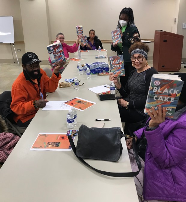 Matteson Public Library staff member Jihan Davis, standing, leads a session of the library's African American Book Club. It meets the fourth Wednesday of the month. (Matteson Public Library)