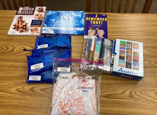 Anyone with a Worth Public Library card or who has borrowing rights in the suburban library system can check out items such as this memory kit, which is designed for seniors who have dementia or Alzheimer's, as well as their caregivers. The kits include books and hands-on activities to trigger memories or work on hand-motor coordination. (Melinda Moore/Daily Southtown)