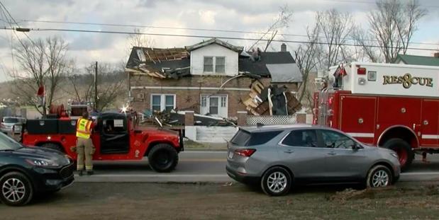 In this frame grab taken from video from WHAS, first responders stage outside a home in Milton, Ky., March 14, 2024, after a severe weather system came through the area. (WHAS via AP)