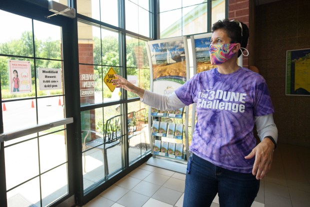 Lorelei Weimer, executive director of Indiana Dunes Tourism, points out measures the visitor center enacted to uphold the Hoosier Hospitality Promise during the COVID-19 pandemic on July 23, 2020. Weimer has stepped back from her leadership role.