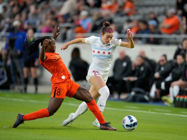 Chicago Red Stars defender Tatumn Milazzo (23) pushes the ball past Houston forward Nichelle Prince (8) during an NWSL Challenge Cup game in Houston on Sunday, March 20, 2022.