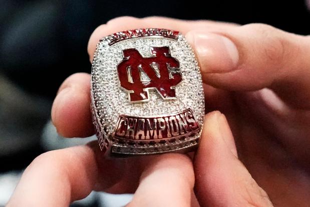 North Central women's wrestling team's Maddie Avila holds a 2023 national collegiate women's wrestling champions ring during a practice at North Central College in Naperville, Ill., Tuesday, March 5, 2024. The team is a national powerhouse even though the program is only a few years old and the school is D-III. (AP Photo/Nam Y. Huh)