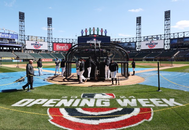 White Sox manager Pedro Grifol, center right, walks near the batting cage during a team workout at Guaranteed Rate Field Wednesday, March 27, 2024, in Chicago. (John J. Kim/Chicago Tribune)