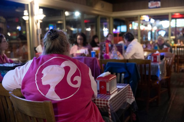 A woman wears the Barbie logo on the back of a jacket during a monthly meeting of Windy City Collectors at Russell's Barbecue in Elmwood Park on Nov. 9, 2023. (Trent Sprague/Chicago Tribune)