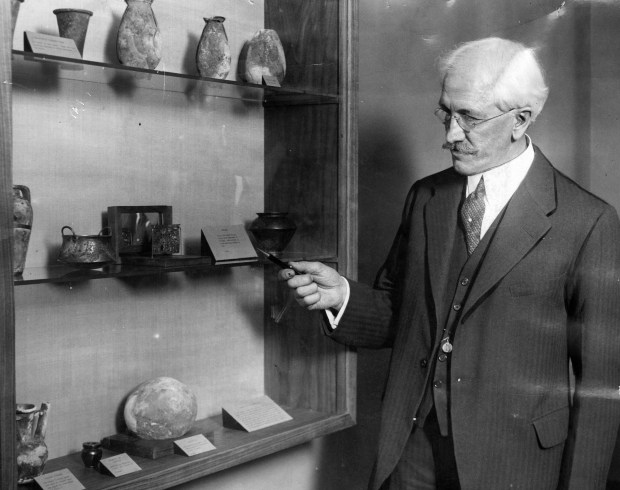 Noted archeologist, Prof. James Henry Breasted of the University of Chicago stands next to some of the relics from the tombs of Egyptian kings, which are his pride. (Chicago Tribune historical photo) 