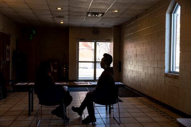 Carla Johnson, a formerly homeless volunteer with the Chicago Coalition for the Homeless, right, talks with volunteer Evie Arlett, left, before canvassing the North Lawndale neighborhood on Saturday, Feb. 17, 2024. The coalition is urging residents to vote in favor of the "Bring Chicago Home" referendum on the upcoming primary ballot. (Vincent Alban/Chicago Tribune)