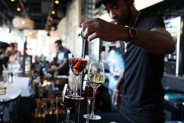 Lead bartender Emmentt Jackson finishes pouring a wine flight during happy hour at Bronzeville Winery, 4420 S. Cottage Grove Ave., May 17, 2023, in Chicago. (John J. Kim/Chicago Tribune)