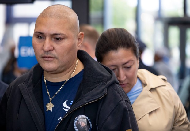 Officer Carlos Yanez Jr. wears a picture of his slain partner, Chicago police Officer Ella French, as he departs the Leighton Criminal Court Building on Oct. 12, 2023, after Eric Morgan, one of the brothers charged in the 2021 shooting that killed Officer French and wounded Officer Yanez, pled guilty. (Brian Cassella/Chicago Tribune)