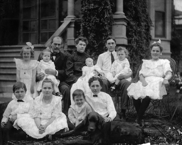 Mayor-elect Edward F. Dunne and his family pose in front of their Austin neighborhood home in 1904 on the day he was elected mayor of Chicago. Dunne was inaugurated the following April. In the back row, from left, are Dorothy, Mr. Dunne holding Jeanette, Mrs. Elizabeth [Kelly] Dunne holding Eugene, Edward F. Dunne Jr holding Geraldine and Eileene. The front row, from left, is Maurice, Mona, Robert and Richard Dunne. (Chicago Tribune historical photo) 