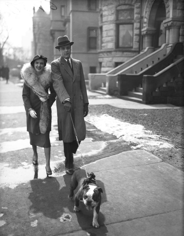 Mr. and Mrs. John Barnes, part of Chicago's "society," stroll down Lake Shore Drive on Easter Sunday with their dog Dandy in 1932. (Chicago Herald and Examiner)