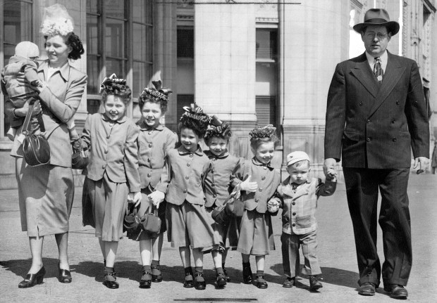 Theresa and Thomas Brennan, of Chicago, took their children for a stroll down Michigan Avenue after attending Our Lady of Sorrows church for Easter in March 1948. The children's matching Easter outfits were designed and made by their mother. The girls are wearing turquoise blue ballerina skirts and jackets with red socks and purses, with white gloves and Easter bonnets made of red and blue ribbons. (Chicago Tribune historical photo)