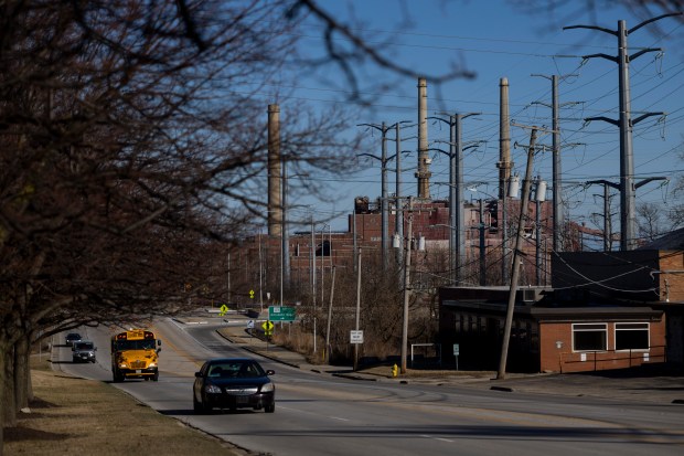 Vehicles drive on Greenwood Ave. where the NRG plant sits off in the distance nearby residential neighborhoods on Wednesday, Feb. 28, 2024, in Waukegan, Ill. (Vincent Alban/Chicago Tribune)