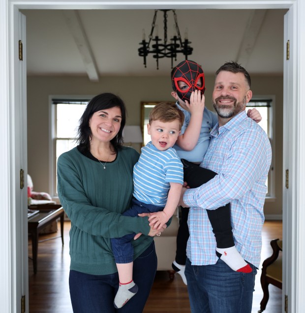 Rachel and Kevin Trenkamp hold their sons, Zachary, 2, center left, and Benjamin, 5, at their home on March 14, 2024, in Aurora. Rachel and Kevin were able to conceive through advanced IVF procedures and technology after several years of unsuccessful attempts. (John J. Kim/Chicago Tribune)
