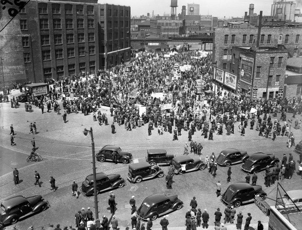 People held signs demanding a shorter work day during a labor parade that started at Union Park and ended at Grant Park on May 1, 1938, in Chicago. (Chicago Tribune historical photo)