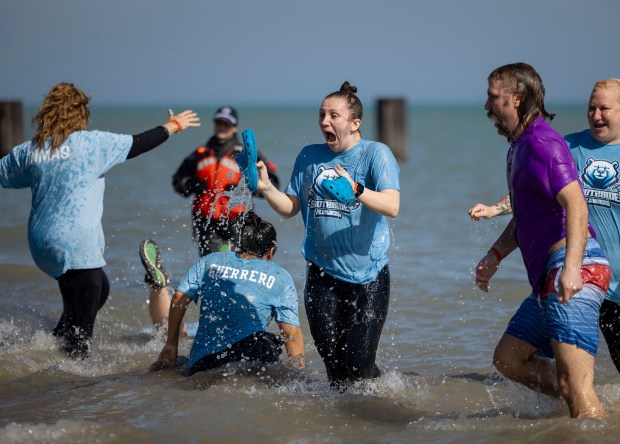 Participants take a dip in Lake Michigan on a warm morning during the 24th Annual Chicago Polar Plunge, Sunday, March 3, 2024, at North Avenue Beach. (Brian Cassella/Chicago Tribune)