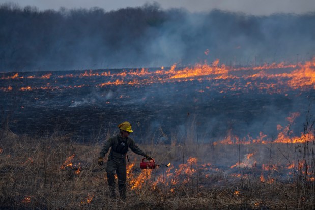 Restoration technician Jacob Churulo guides the controlled burn at Nachusa Grasslands on March 7, 2024. (E. Jason Wambsgans/Chicago Tribune)