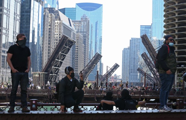 Protesters stand on the Wabash Avenue bridge, as bridges to the west are lifted to prevent movement of people, during a rally and march to remember the May 25 killing of George Floyd by a Minneapolis police officer, in the Loop on Saturday, May 30, 2020, in Chicago. (John J. Kim/Chicago Tribune)