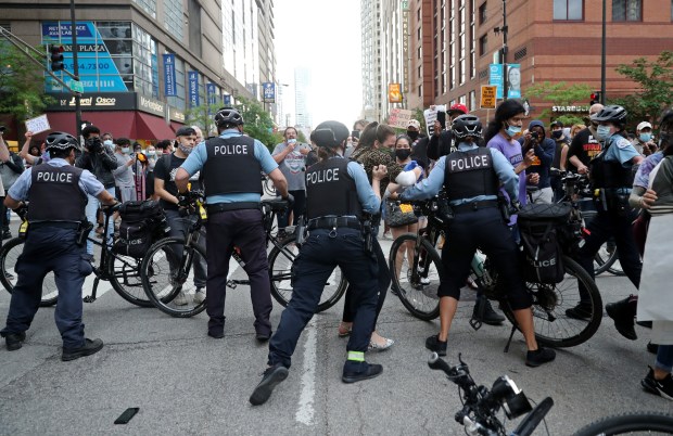 Protesters attempt to break through a police barrier during a march to bring attention to the May 25 murder of George Floyd by a Minneapolis police officer, in the Near North neighborhood Friday, May 29, 2020, in Chicago. (John J. Kim/Chicago Tribune)