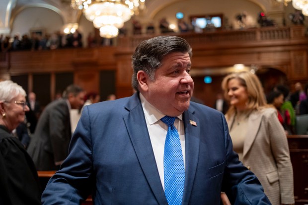 Gov. J.B. Pritzker greets lawmakers as he arrives to deliver his State of the State and budget address before the General Assembly at the Illinois State Capitol, Wednesday, Feb. 21, 2024. (Brian Cassella/Chicago Tribune/pool)