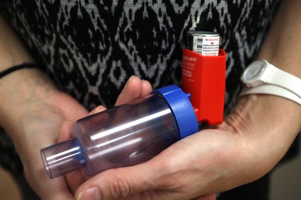 School nurse Keri Personnete holds a child's inhaler in the nurse's office at the Barrington Early Learning Center in Barrington on Wednesday, Feb. 15, 2017. (Stacey Wescott/Chicago Tribune)