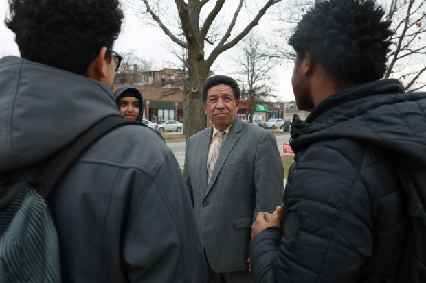 Illinois 1st District Appellate Judge Jesse G. Reyes, a candidate for the Illinois Supreme Court, talks with students outside an early voting polling place at the Oak Park Village Hall on March 7, 2024. (John J. Kim/Chicago Tribune)