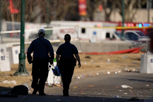 Emergency medical technicians walk around the scene of a fatal shooting following the Kansas City Chiefs' super Bowl victory parade on Feb. 14, 2024, in Kansas City. (Charlie Riedel/AP)