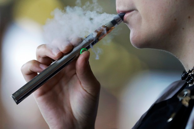 A teen uses an e-cigarette on Oct. 4, 2019, in Mayfield Heights, Ohio. (Tony Dejak/AP)