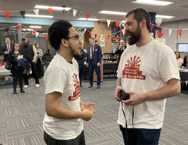 A North Chicago Community School District 187 student and staff member help at the kickoff event. (Steve Sadin/Lake County News-Sun)