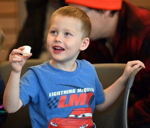 Mason Schaller, 4, of Lake Zurich, shows delight tasting a sample in the program room of the Welcome Center before the maple syrup hike portion at Ryerson Conservation Area in Riverwoods on March 9, 2024. (Karie Angell Luc/Lake County News-Sun)