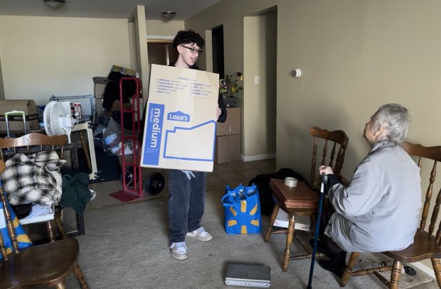 Sixteen-year-old Benito Reyna helps his family pack everything from his uncle's apartment while his 86-year-old grandmother looks on, one week after a tornado caused the complex to be deemed uninhabitable. (Yadira Sanchez Olson/Lake County News-Sun)