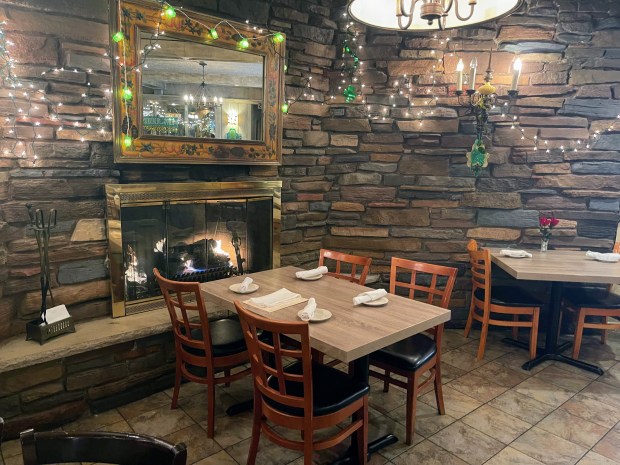 Couples have gotten engaged, and have celebrated numerous life events at the table in front of the fireplace at Amici, according to the owner Sarah Zimmerman. Credit: Richard Requena