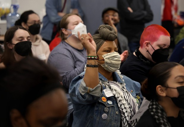 Activist Amadi Hall reacts to speaker Joe Iosbaker during a meeting of the Coalition to March on the Democratic National Convention (DNC) on Saturday, April 13, 2024, in Chicago. Activists and organizers came together to plan their efforts of opposition to the Democratic National Convention taking place this August in Chicago. (Stacey Wescott/Chicago Tribune)