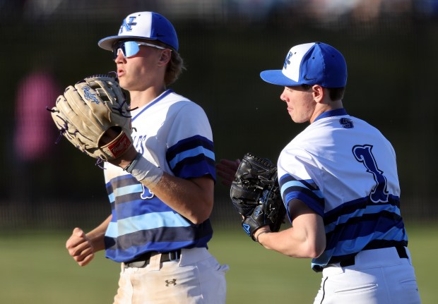 St. Charles North's Joshua Caccia (1) right, and Parker Reinke (13) return to the dugout during a DuKane Conference game against Batavia on Monday, April 15, 2024 in St. Charles. Caccia garnered the school's strikeout record.H. Rick Bamman / For the Beacon-News