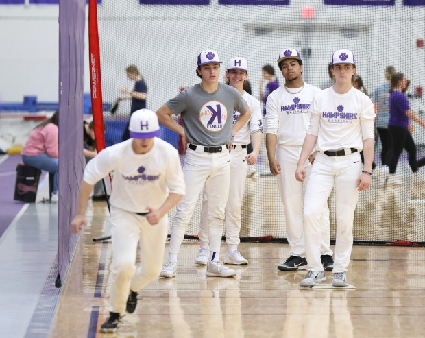 Hampshire shortstop Dominic Borecky (gray shirt) waits for his turn during drills at Hampshire on Friday, April 5, 2024. Trent Sprague / The Beacon-News)