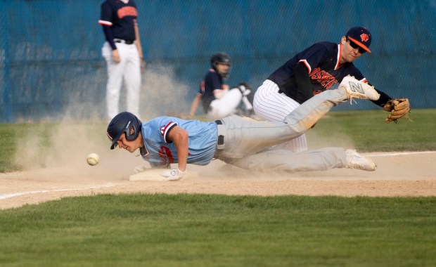 West Aurora's Logan Weaver (6) slides safely to third base during a game at Oswego High School in Oswego on Monday, April 22, 2024. (Nate Swanson/for the Beacon-News)