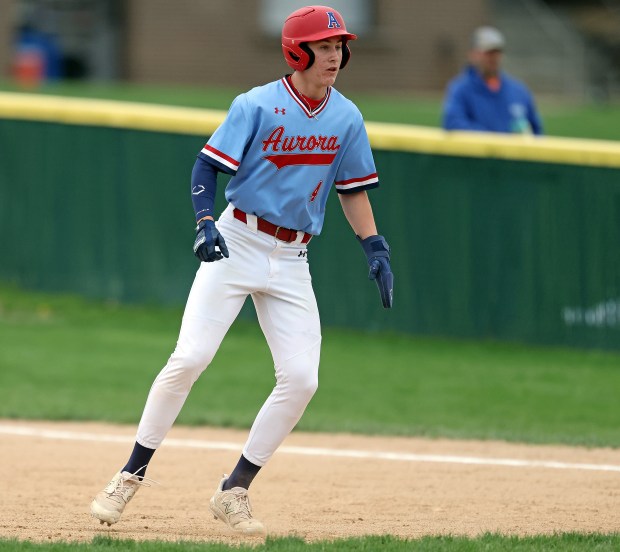 West Aurora's Mason Atkins (4) takes his lead off of first in the first inning against Yorkville during a rain shortened Southwest Prairie Conference game in Aurora on Thursday, April 18, 2024. H. Rick Bamman / For the Beacon-News