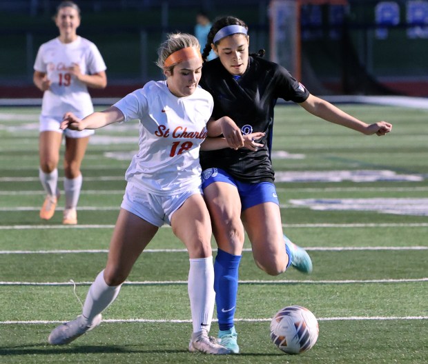 St. Charles East's Payton Rivard and St. Charles North's Juliana Park battle for the ball during the soccer game Tuesday, April 23, 2024, in St. Charles. (James C. Svehla/for the Beacon News)