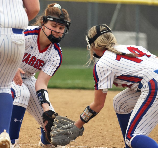 Dundee-Crown's McKayla Anderson (10), left, and Brianna Hamblen (14) slap gloves after an Anderson strike out in the sixth inning during a Fox Valley Conference game against Jacobs on Wednesday, April, 10, 2024 in Algonquin. Dundee-Crown won, 10-0.H. Rick Bamman / For the Beacon News