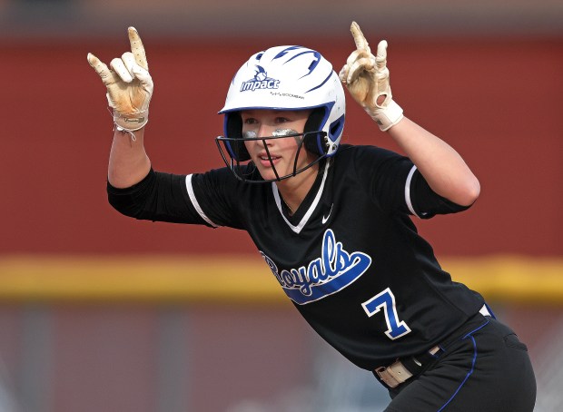 Larkin's Brynn Kerber (7) stands on first after being hit by a pitch as she acknowledges her coach during a Upstate Eight Conference game in South Elgin on Monday, April 22, 2024. South Elgin won, 10-0 in five innings.H. Rick Bamman / For the Beacon-News