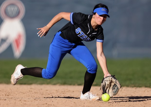 St. Charles North's Maddie Hernandez (2) scoops up a grounder for an out at first during a non-conference game against West Aurora on Monday, April, 8, 2024. St. Charles North won, 13-0.H. Rick Bamman / For the Beacon News