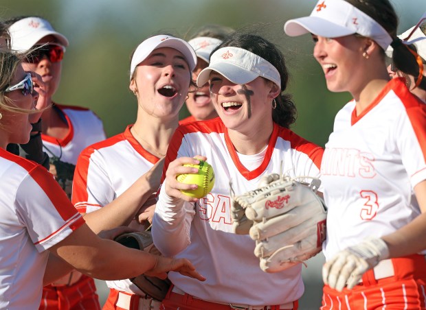 St. Charles East's Holly Smith, center, celebrates with teammates her final out catch with bases loaded against St.Charles North during a DuKane Conference game in St. Charles on Friday, April 19, 2024. St. Charles East won, 4-3.H. Rick Bamman / For the Beacon-News